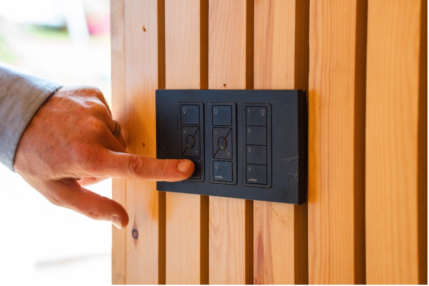 Pressing a Lutron wall control installed by Allview Electrical